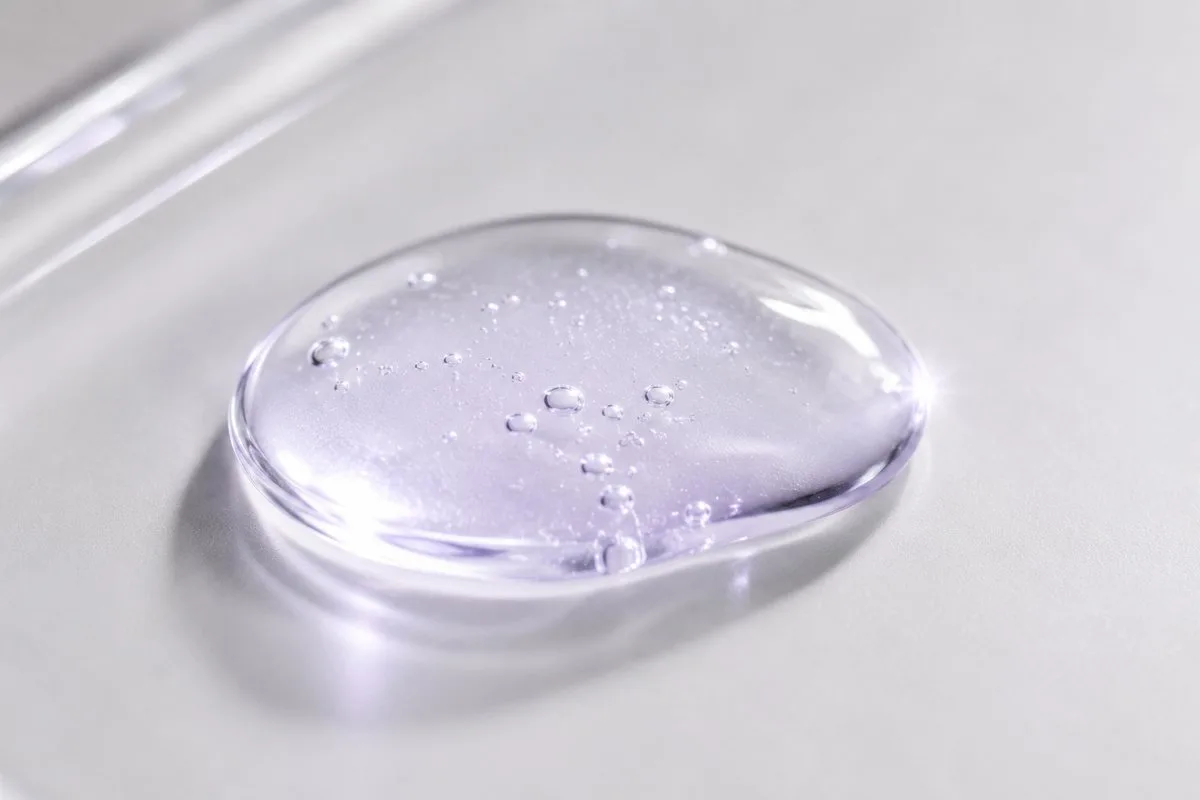 Macro of the lightweight violet-tinted serum texture